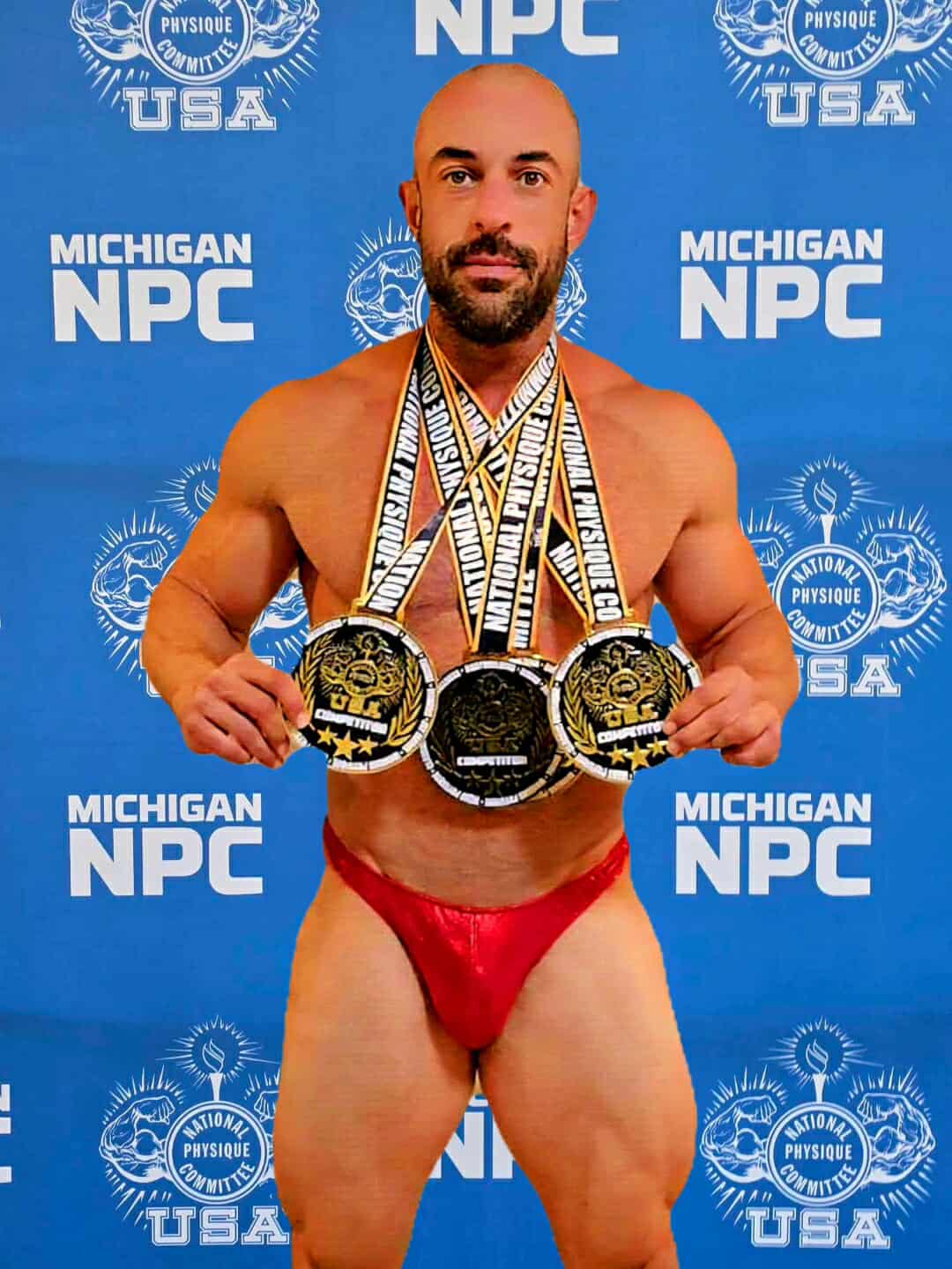 Stage front pose with medals backdrop